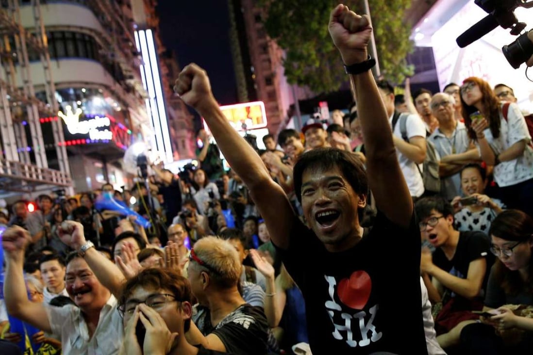 Supporters of the Hong Kong badminton team watch the live broadcast of the mixed doubles match between Hong Kong and China at the Rio Olympics. The broadcast, in Mong Kok, was organised by independence advocates. Photo: Reuters