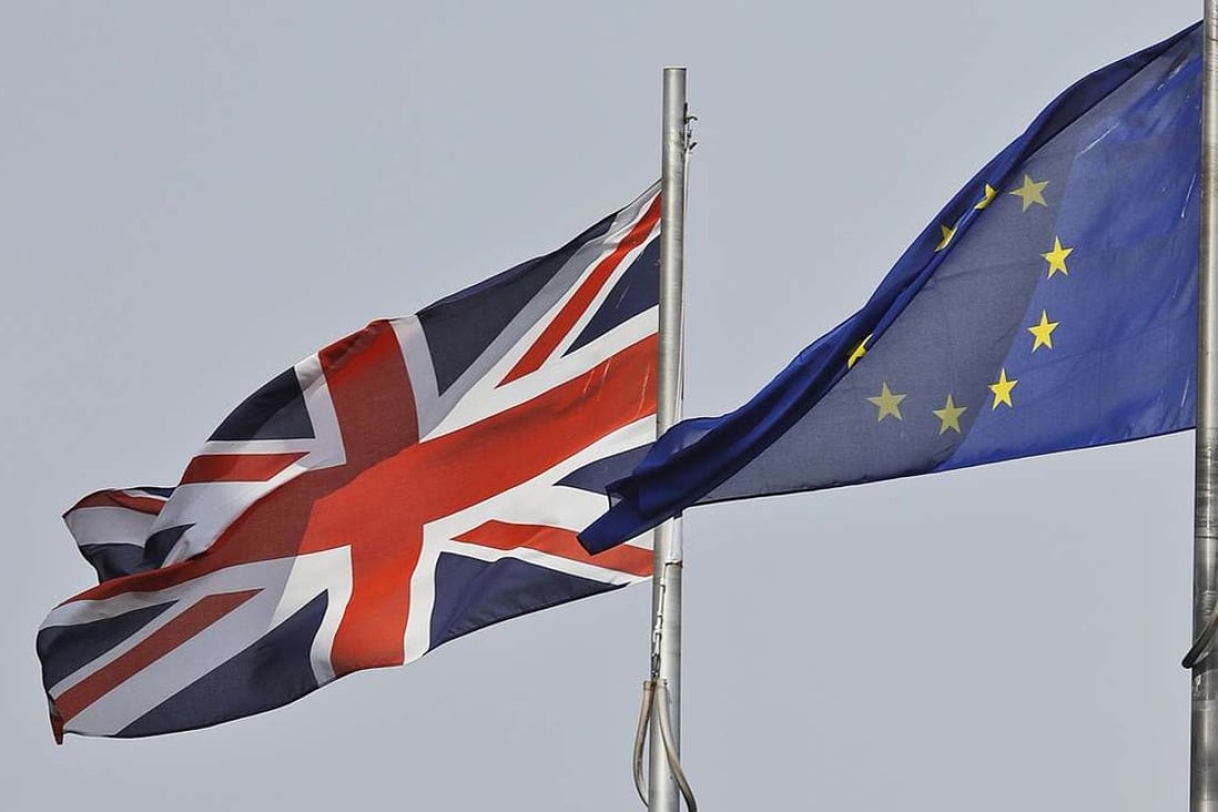 A Union Jack flag and a European flag blow in the wind in front of the city hall in London. Photo: AP