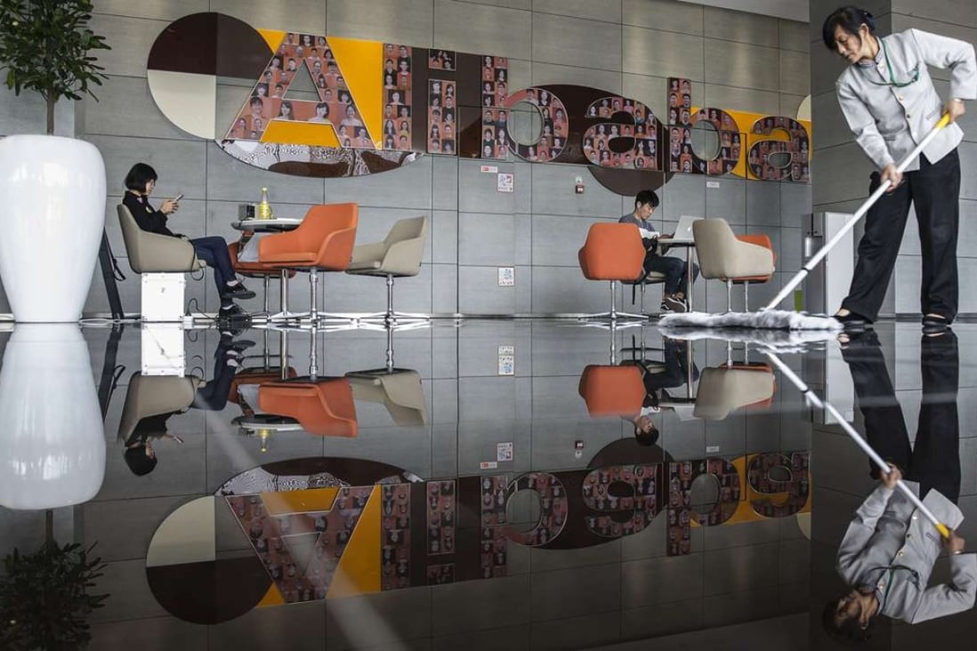 An employee mops the floor in a building lobby at the Alibaba Group Holding Ltd. headquarters in Hangzhou, China, on Tuesday, Oct. 13, 2015. Alibaba's bet on data technology is driving greater investment in areas including ways to protect user privacy as it battles Amazon.com Inc. for customers globally. Photographer: Qilai Shen/Bloomberg ORG XMIT: 585718101