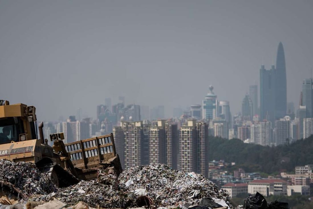 Shenzhen tower blocks loom over a landfill in the New Territories, Hong Kong. Nearly 40 per cent of the city’s municipal solid waste is composed of food. Photo: AFP