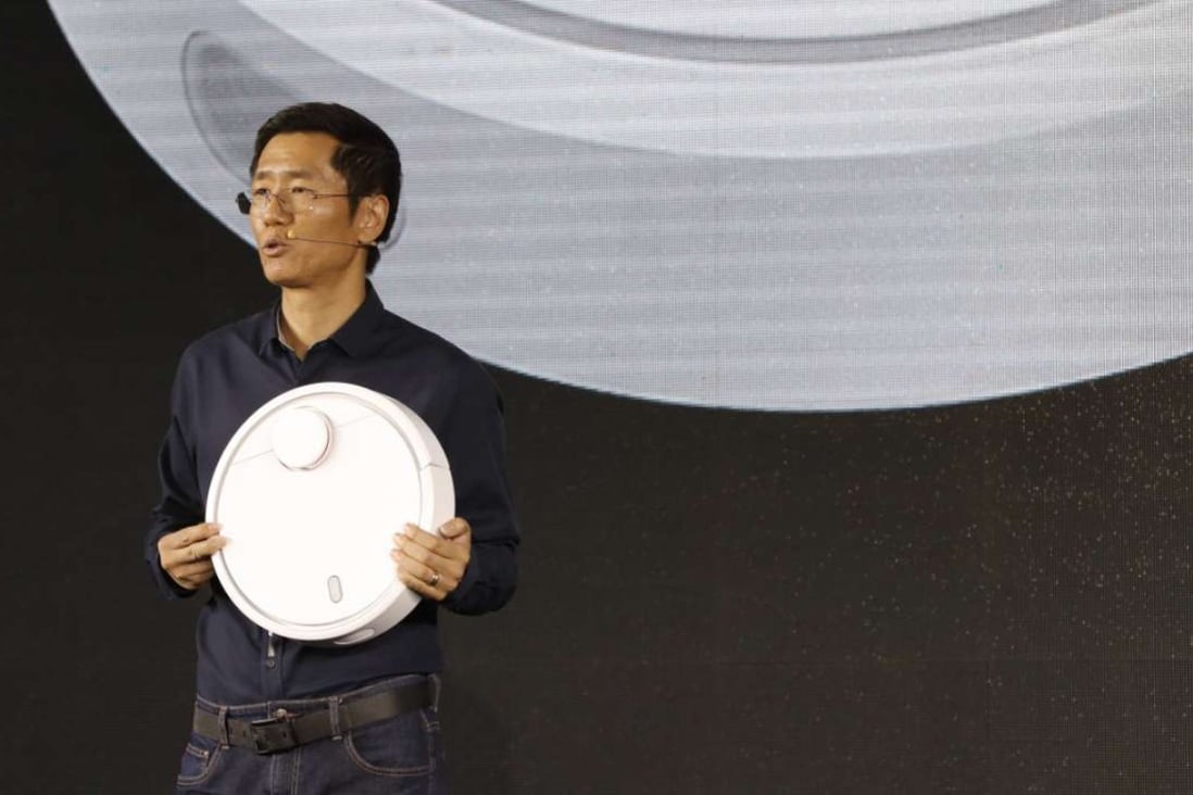 Xiaomi co-founder and vice president Liu De introduces the features of the Mi Robot Vacuum in Beijing on Wednesday. Photo: Xiaomi