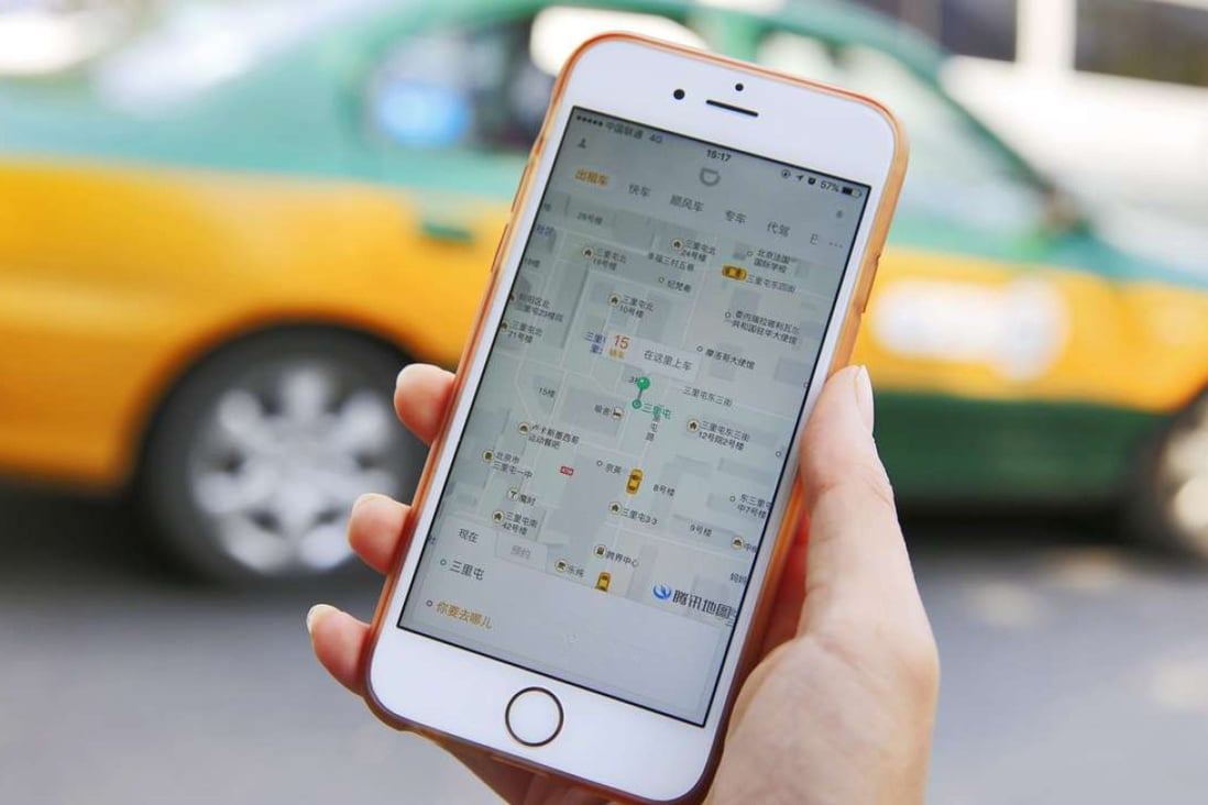 A commuter shows the Didi Chuxing app on her iPhone in Beijing. Photo: EPA