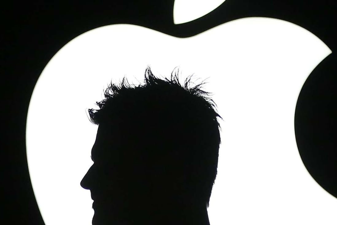 This file photo taken on September 9, 2015 shows the shadow of a man in front of the Apple logo in New York City. The European Union on August 30, 2016 orders Apple to pay a record 13 billion euros in back taxes in Ireland, saying deals allowing the US tech giant to pay almost no tax were illegal. In a ruling that is set to anger Washington, the European Commission says the world's most valuable company avoided tax bills on almost all its profits in the bloc under the arrangements with the Irish government. / AFP PHOTO / GETTY IMAGES NORTH AMERICA / Andrew Burton