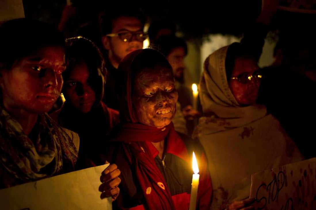 Acid attack survivors participate in a candlelit vigil protesting violence against women in New Delhi in 2014. Photo: AP