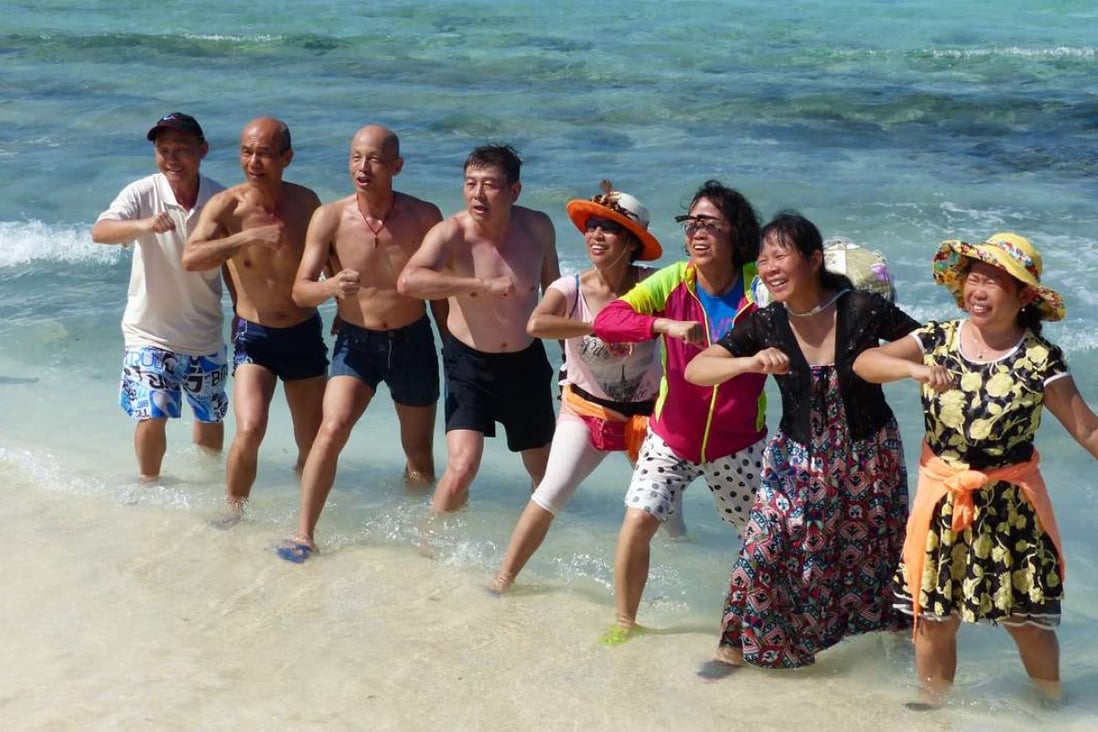Chinese tourists sing and dance to patriotic songs on Silver Islet in the Paracel Islands. Photo: SCMP Pictures