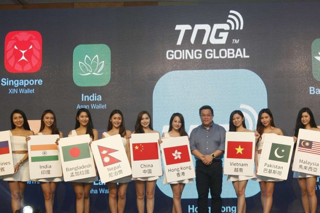TNG Wallet founder and chief executive Alex Kong seen on Tuesday with models representing the different regions that the Hong Kong-based electronic wallet is now servicing. Photo: SCMP Pictures
