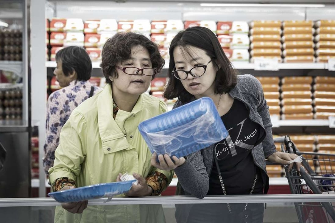 Two women shop at a supermarket in Tianjin. The retired tend to eat less. In the rich world, the elderly spend 25 per cent less on the things they typically consumed before, but more on health care and their families. Photo: Bloomberg