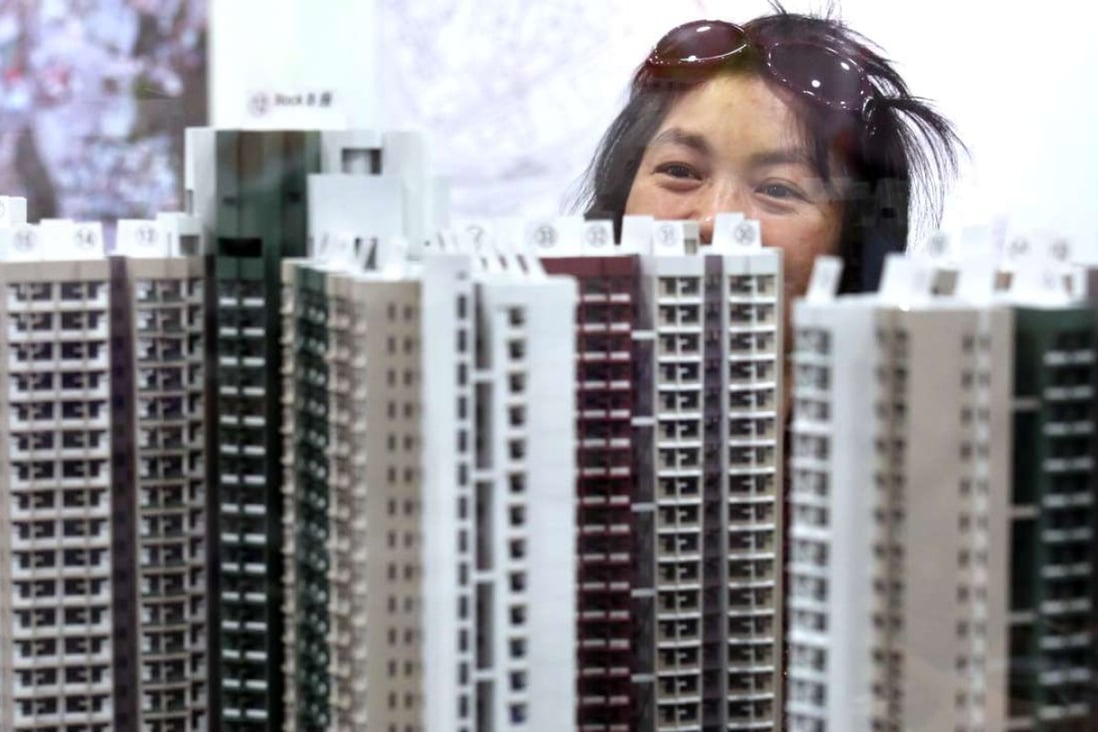 Buyers examine models of Home Ownership Scheme flats during the first day's application at on July 16,2016. Photo: Nora Tam