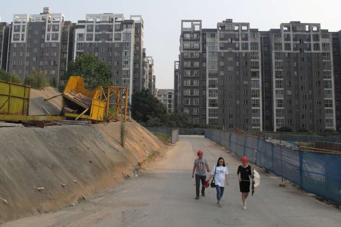 People walk in a construction site near a residential complex in Changsha, Hunan province. Photo: Reuters