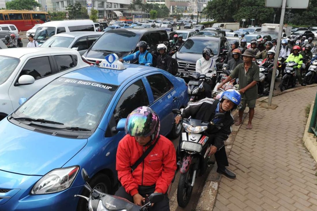 Commuters drive in heavy traffic in Jakarta. Photo: AFP