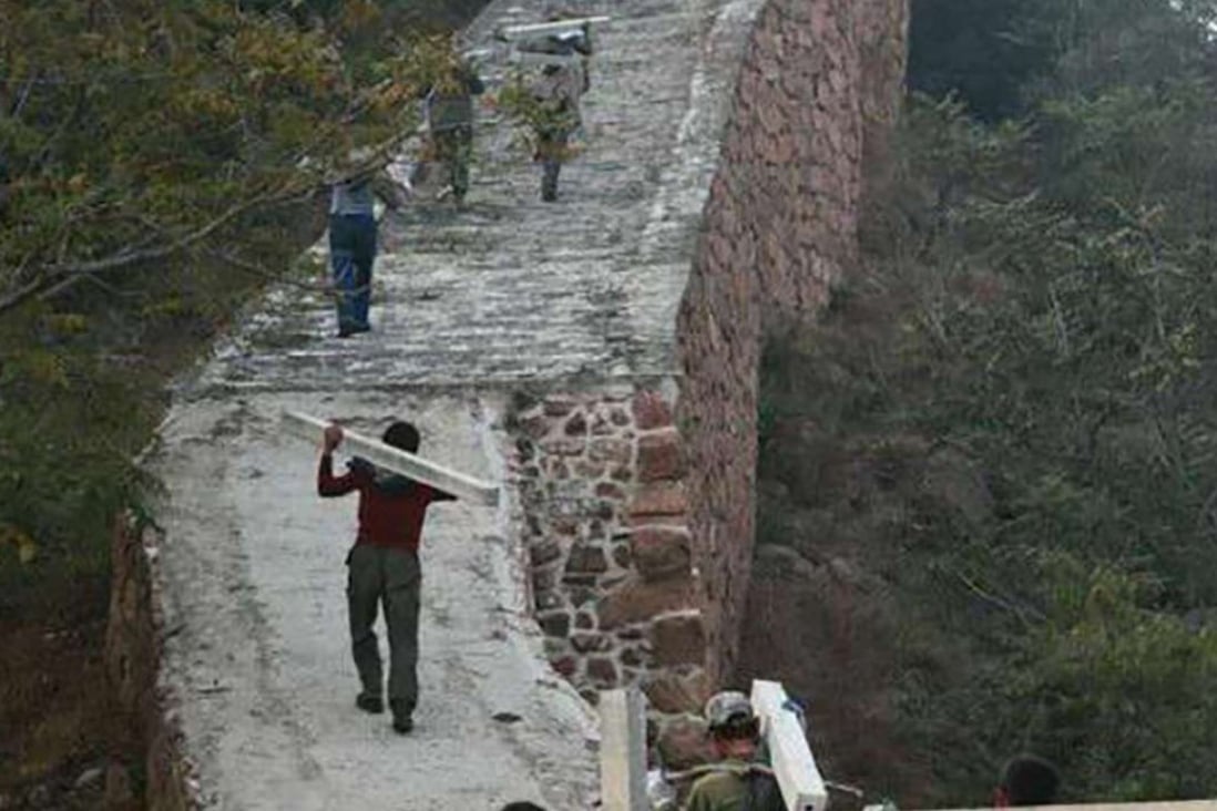 Villagers carry concrete posts up the Great Wall. Photo: SCMP Pictures