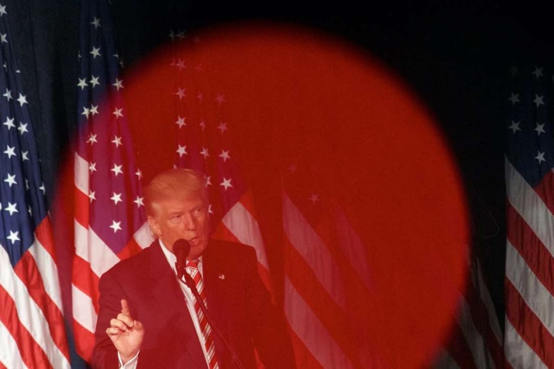 Republican presidential nominee Donald Trump is seen through the red light of a videographer's camera while delivering a speech at The Union League of Philadelphia. Photo: AFP