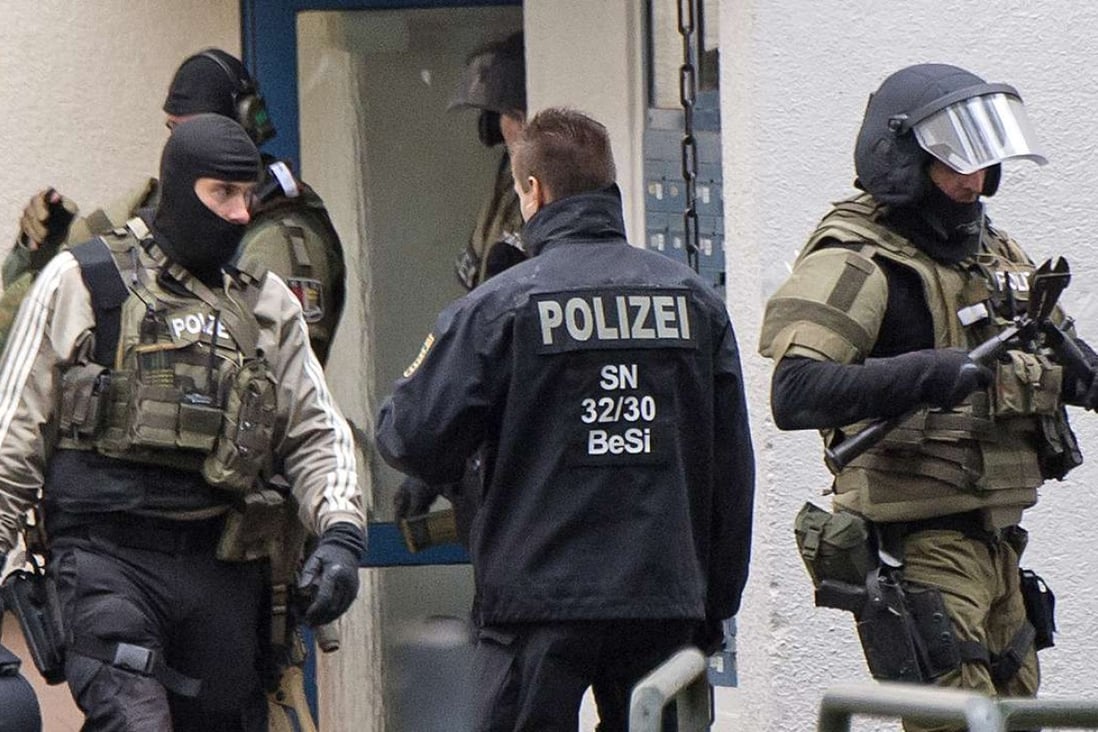 Police officers leave an apartment after detonations in the city of Chemnitz. Photo: AP
