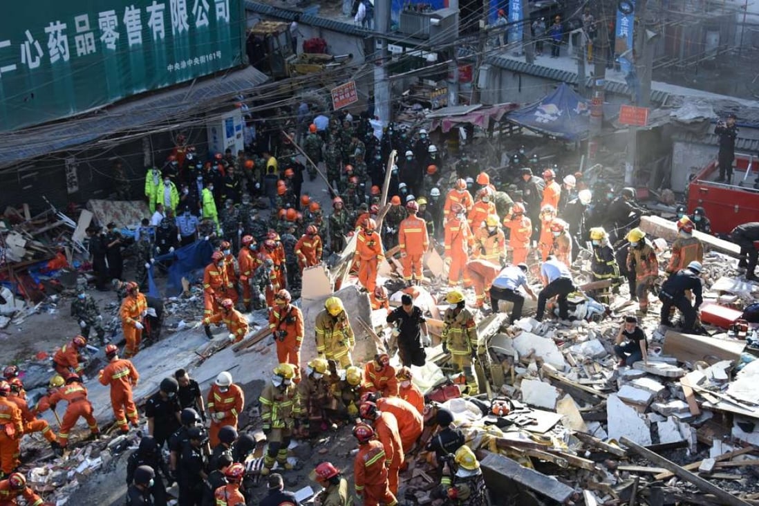About 800 rescuers search for survivors after four residential buildings collapsed early on Monday. Photo: Xinhua