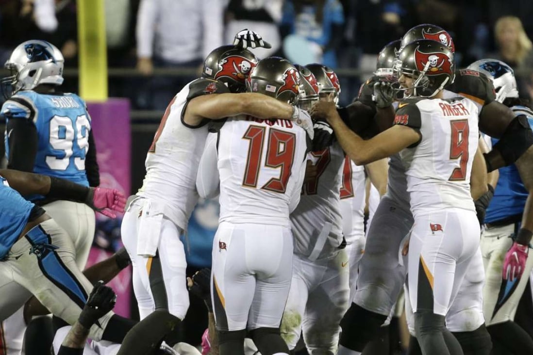 Tampa Bay Buccaneers players celebrate with kicker Roberto Aguayo (19) after his game-winning field goal against the Carolina Panthers in the second half of an NFL football game in Charlotte, N.C., Monday, Oct. 10, 2016. (AP Photo/Bob Leverone)