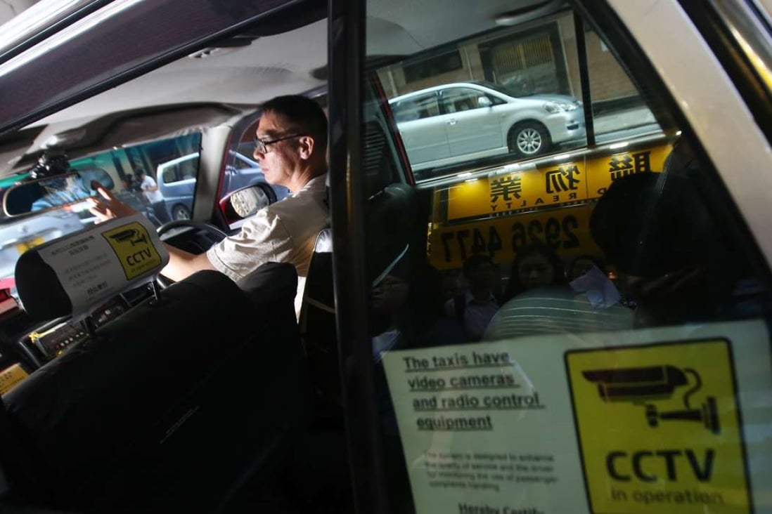 Taxi driver Leung Wing-hong shows on-board surveillance cameras in a taxi. Photo: David Wong