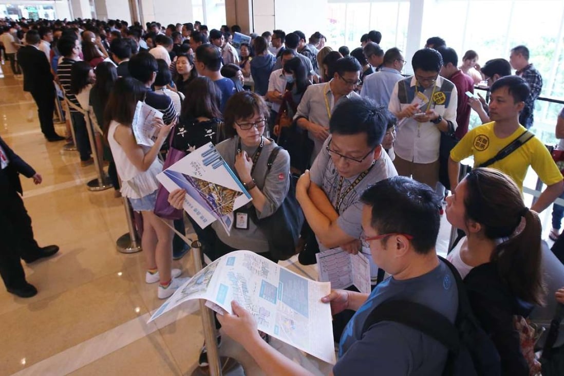 Queues formed at the sales office of China Overseas Land's One Kai Tak development in Hong Kong last month. Strong sales have boosted the company’s third-quarter profits. Photo: Felix Wong