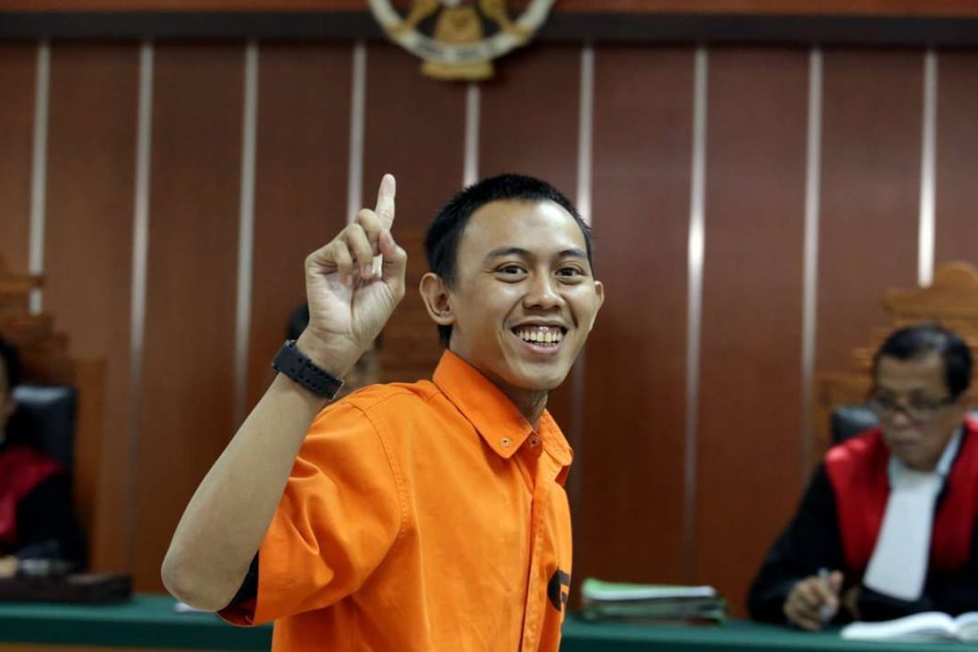 Indonesian militant Dodi Suridi, 23, smiles during his trial in Jakarta. Photo: EPA