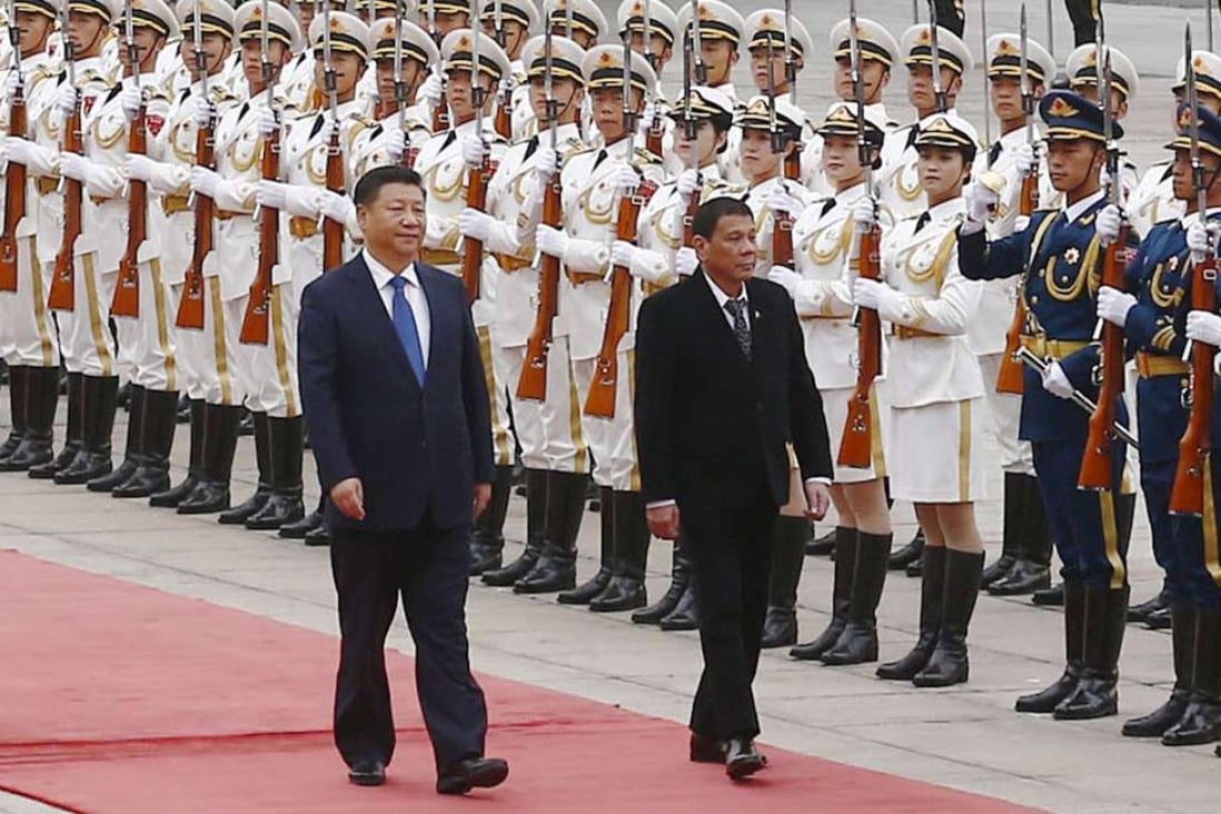 President Xi Jinping (left) and Philippine President Rodrigo Duterte heads for talks at the Great Hall of the People in beijing on Thursday. Photo: Kyodo