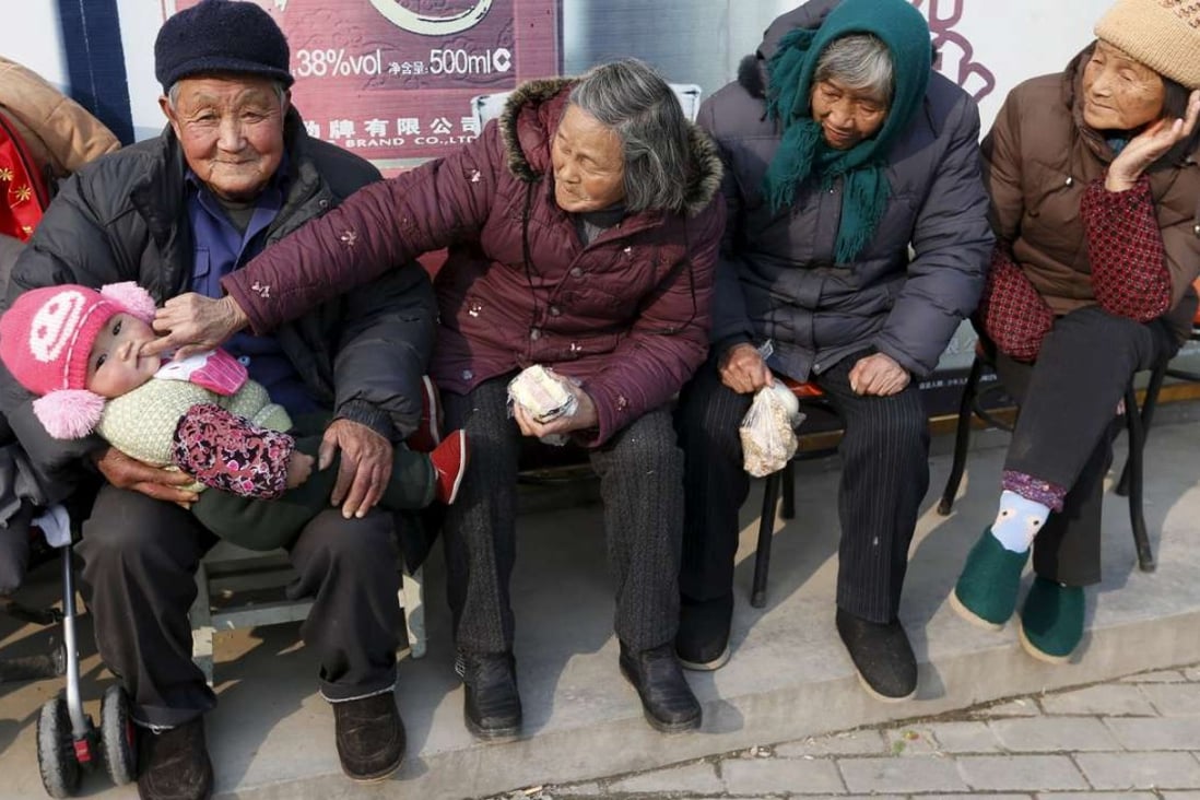 An elderly couple feed their great-grandson as they sit in the winter sun in Jiaxing, Zhejiang province. By last year, China’s so called baby-boomers – those older than 65 – had grown to 144 million or 10.5 per cent of the population. Photo: Reuters