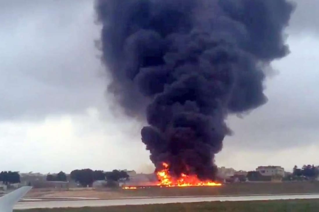 A passenger on another plane captured this image of the blazing wreckage of an unmarked plane at Malta International Airport ion Monday. Photo: EPA