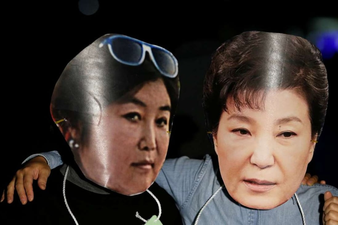 Protesters wearing masks of South Korean President Park Geun-hye (right) and Choi Soon-sil at a protest denouncing the president over an influence-peddling scandal. Photo: Reuters