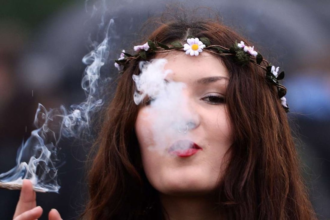 In this 2014 file photo, a woman smokes cannabis at a pro-legalisation event in Hyde Park in London. Photo: EPA