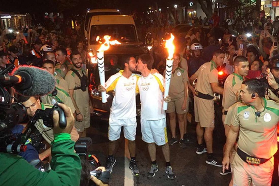 Two men celebrating the beginning of the Rio 2016 Olympic Games with a kiss. Photo: Twitter