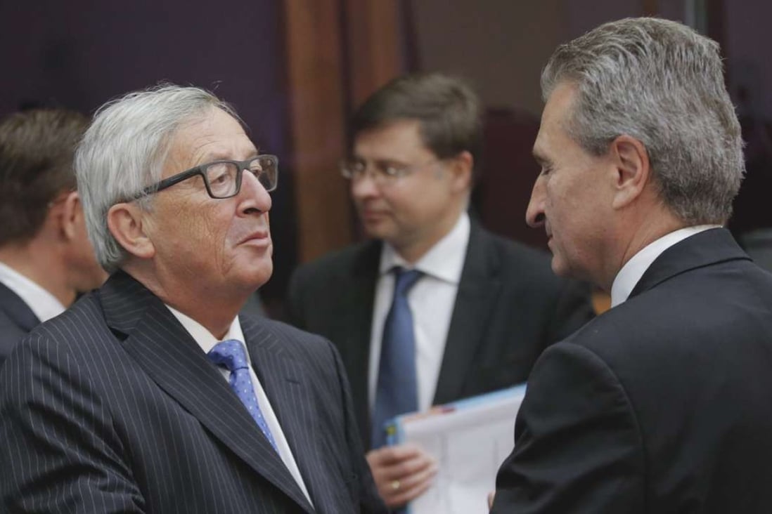 German EU Commissioner fGuenther Oettinger (right), pictured with European Commission President Jean-Claude Juncker (L), says he was not trying to be derogatpry by calling Chinese people slitty-eyed. Photo: EPA
