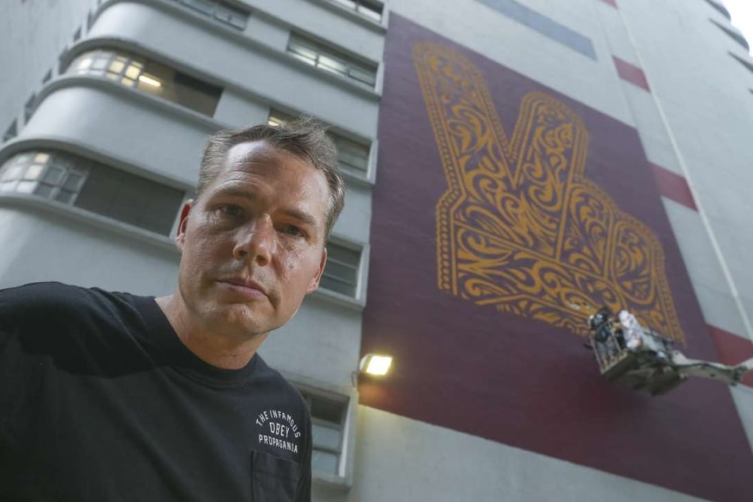 Street artist Shepard Fairey and his mural on Cornwall House in Quarry Bay. Photo: K.Y.Cheng