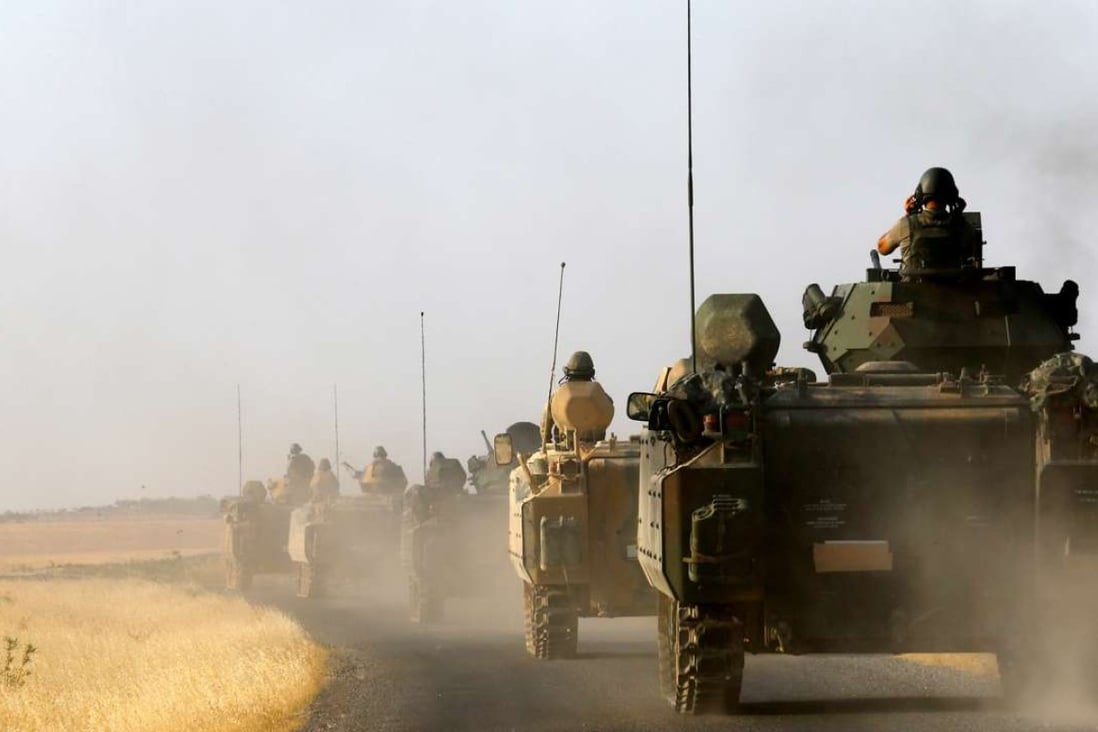 Turkish armoured personnel carriers drive towards the Turkish-Syrian border in late August. A deployment of Turkish forces near the border with Iraq is now stoking tension with Baghdad. Photo: Reuters