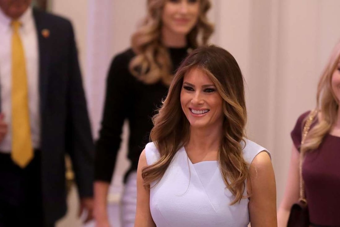 Melania Trump (C), wife of Republican presidential nominee Donald Trump, arrives for the grand opening ceremony at the new Trump International Hotel in Washington, DC. Photo: AFP
