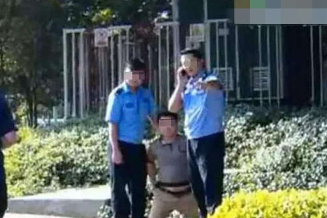 The driver is restrained in the street in Shenzhen. Photo: Guangdong TV