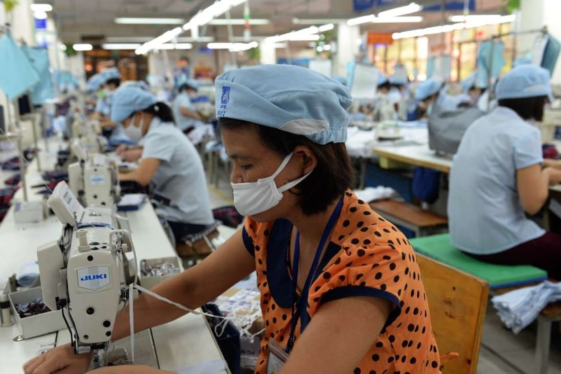 Workers on a garment production line on the outskirts of Hanoi. Vietnam was projected to see the biggest percentage boost to the economy of any country in the TPP – about 10 per cent by 2030, mostly thanks to textiles and apparel. File photo: AFP