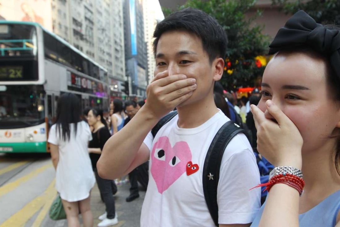 People cover their face during air pollution index because of the roadside air pollution. Photo: Edward Wong