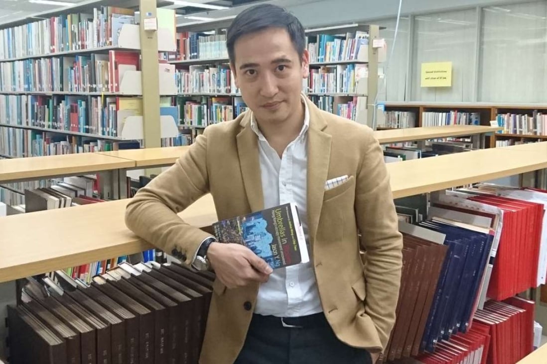 Jason Ng with a copy of his new book, Umbrellas in Bloom. Photo: Elaine Yau
