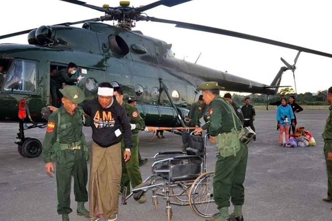 Soldiers help people injured in fighting in Lashio, northern Myanmar, on Sunday. Photo: EPA