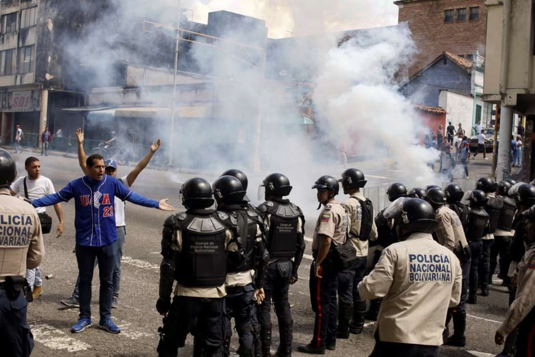 Riot police clash with protesters during a rally demanding a referendum to remove Venezuela's President Nicolas Maduro in San Cristobal, Venezuela, earlier this month. Photo: Reuters