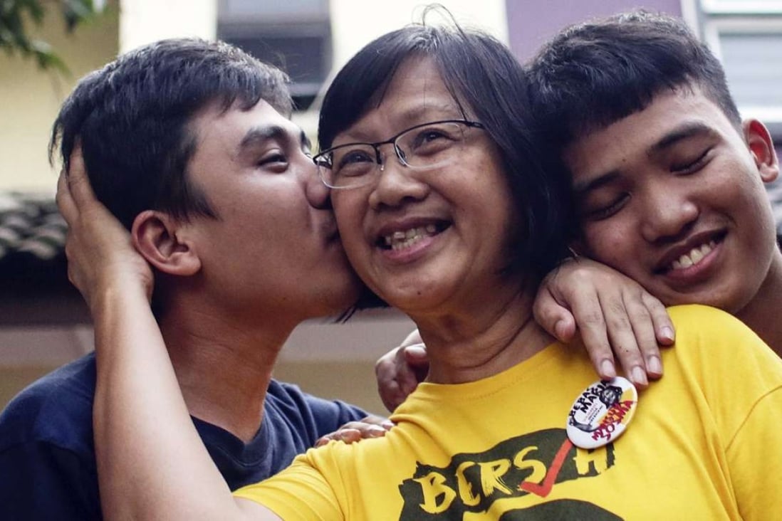 Head of electoral reform group BersihMaria Chin Abdullah is embraced by her sons after being released by Malaysia Royal Police. Photo: EPA