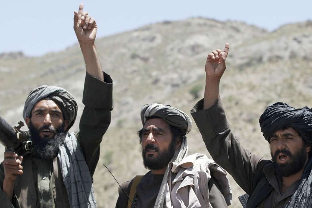 Taliban fighters react to a speech by their senior leader in the Shindand district of Herat province, Afghanistan. Photo: AP