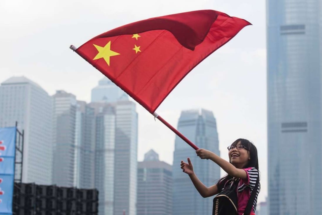 A young woman waves the national flag at a rally last month in support of the NPC’s interpretation of the Basic Law. Hong Kong people must fight the independence movement openly, with flags waving. Photo: AFP
