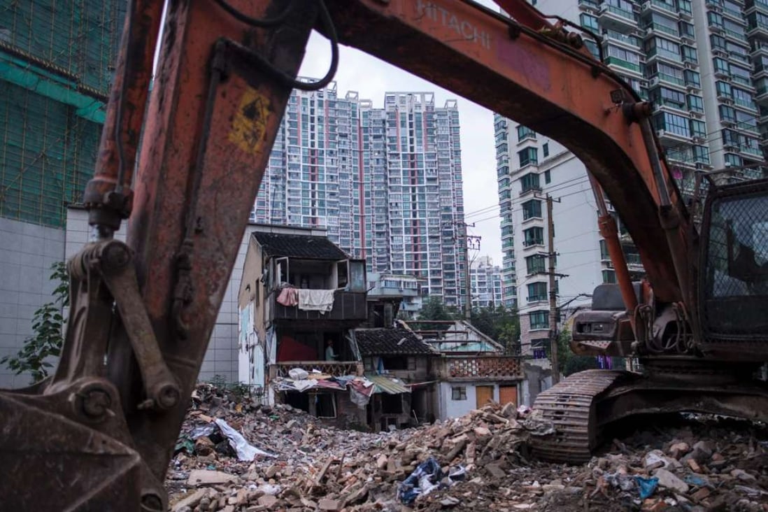 A man works at a site for residential buildings to make space for high-rise buildings in Shanghai. Photo: AFP