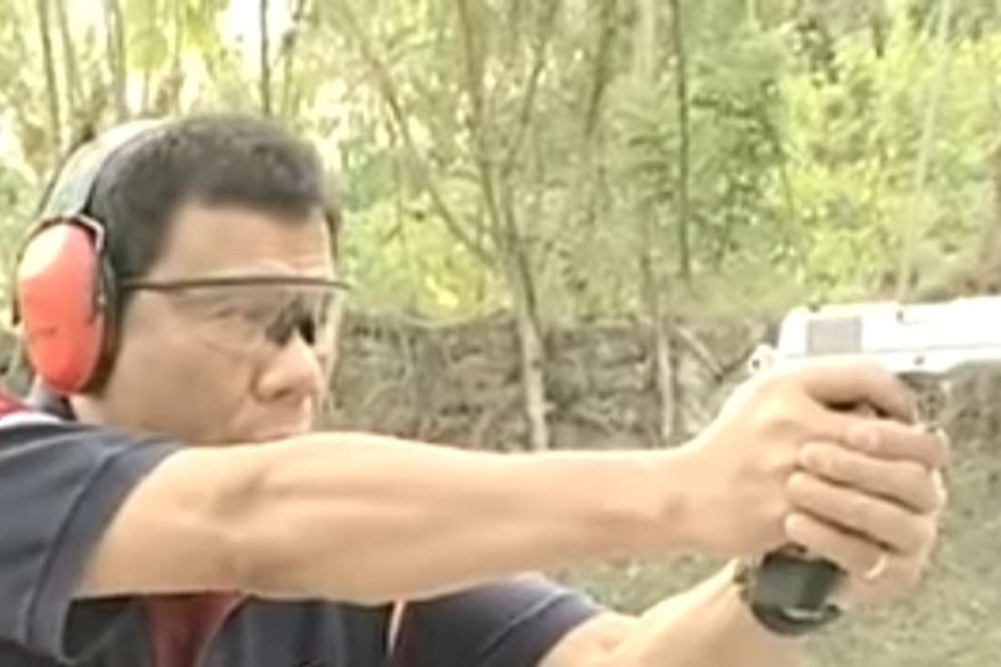 Rodrigo Duterte fires a pistol at a shooting range. The Philippine president said he personally killed suspected criminals when he was mayor of a southern city to set an example for police. Photo: YouTube