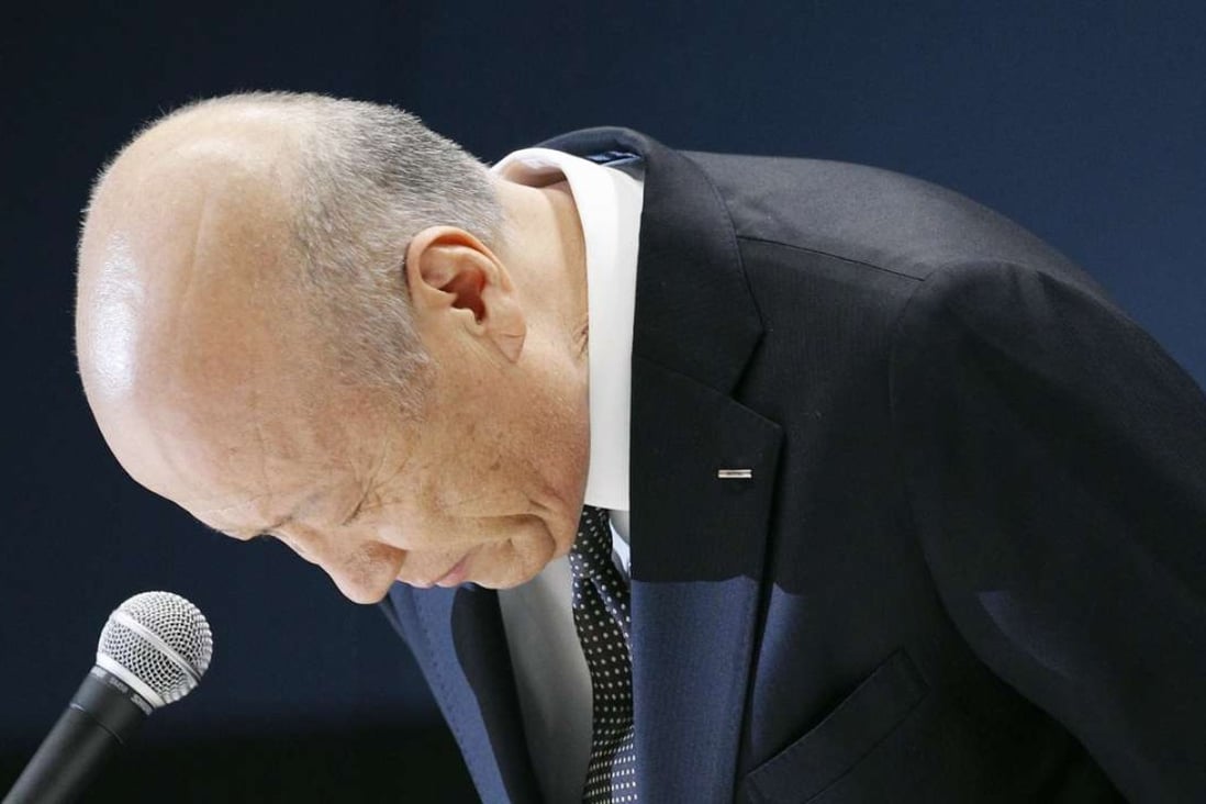 Tadashi Ishii, president of advertising giant Dentsu Inc., bows in apology at a press conference in Tokyo. Ishii said he will step down in January 2017 to take responsibility for the overwork-related suicide of a 24-year-old female employee. Photo: Kyodo