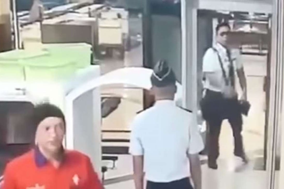 YouTube footage showed 32-year-old pilot Tekad Purna staggering through a metal detector at airport security and dropping his bag and belongings several times after arriving late for his flight.