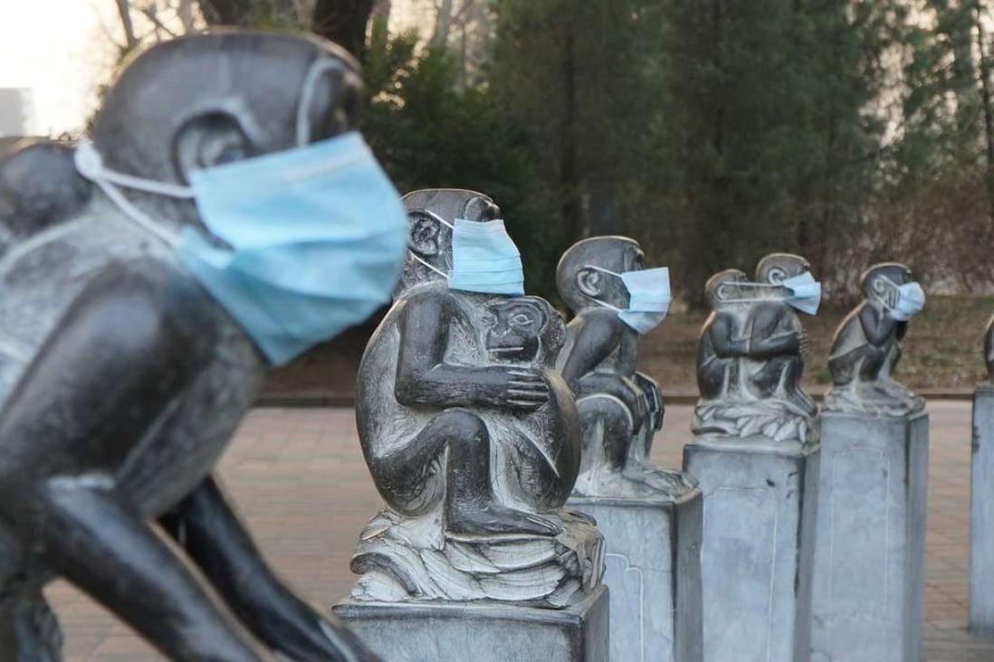 Face masks on stone monkey statues in protest at the current heavy air pollution in Beijing. The capital issued its highest “red” fog alert for a second day running on Wednesday. Photo: AFP