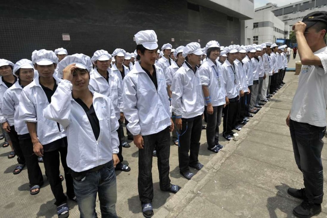 Foxconn workers line up outside a factory building in Shenzhen in May 2010. Photo: AFP