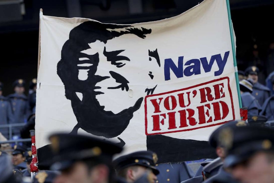 Cadets from the US Military Academy fly a banner depicting Donald Trump prior to the game between the Navy Midshipmen and the Army Black Nights at M&T Bank Stadium in Baltimore, Maryland. Photo: AFP