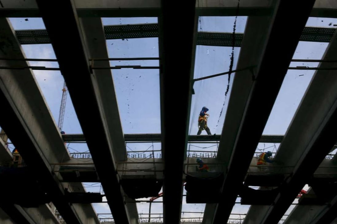 Labourers work on a new skyway under construction along on a main busy street in Manila November 26, 2015. Asian economies are working hard to achieve sustainable urbanisation and boosting asset productivity. Photo: Reuters
