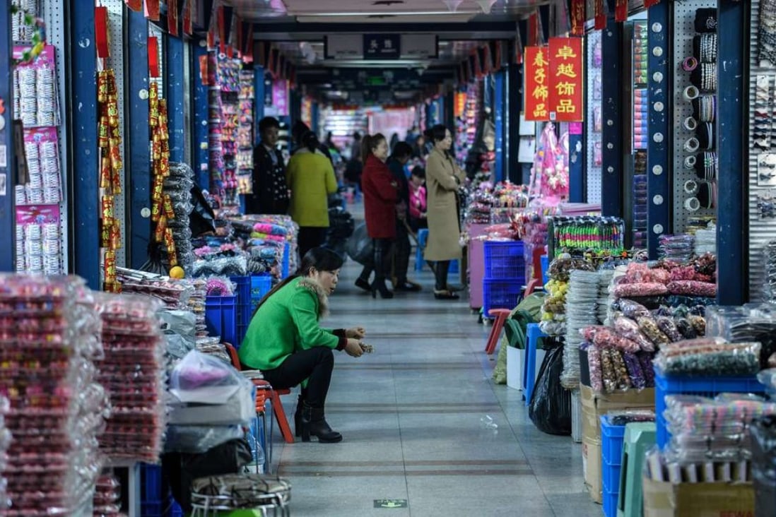 A vendor at the Yiwu wholesale market in Zhejiang province. Rising global protectionism and sluggish demand from consumers are already hurting China’s exports. Photo: AFP